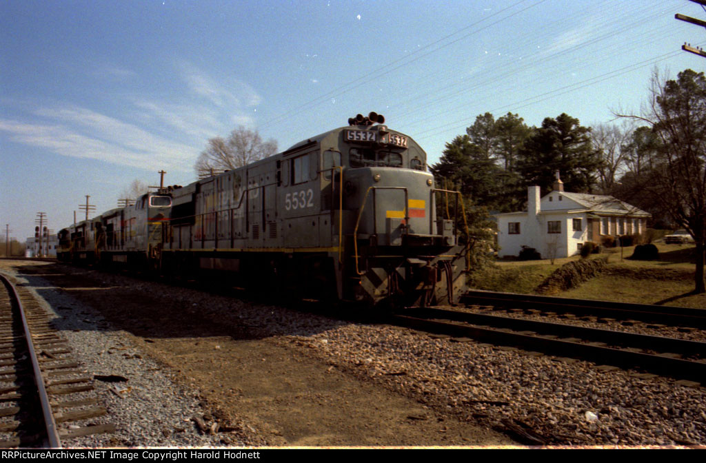 SBD 5532, 5134, and two other GE units are backing down to their train